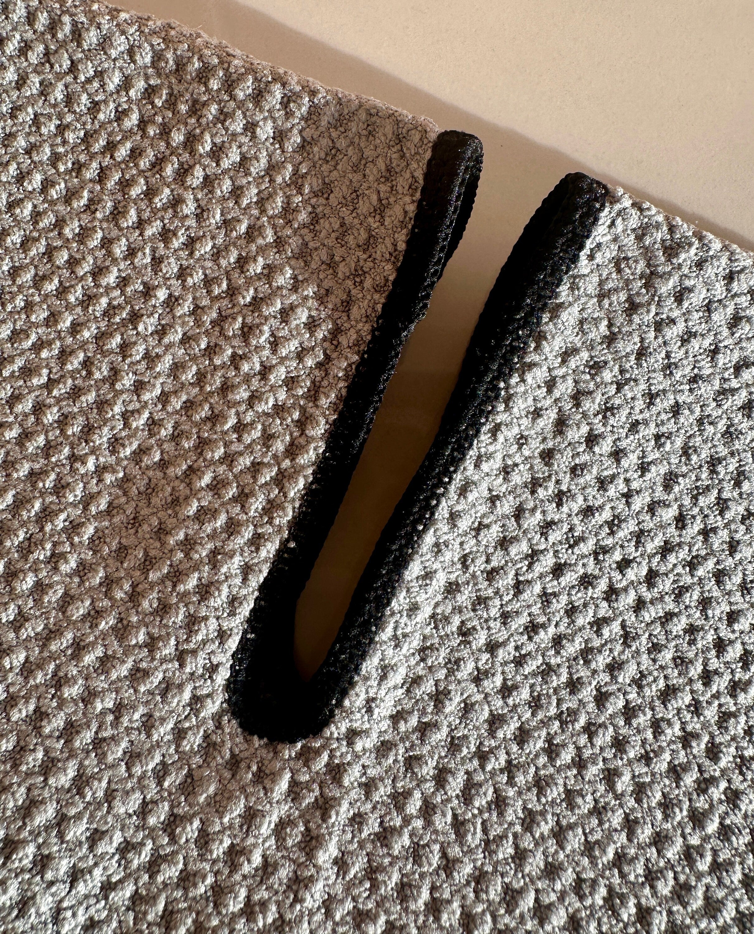 Close-up of 8" slit in custom, personalized golf towel. The one in the photo is gray with black edges.