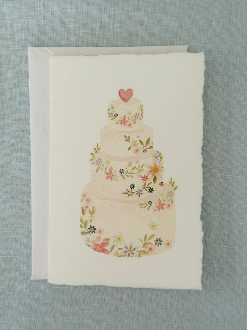 Four tier wedding cake in watercolor on handmade paper with flower and a heart on top.
