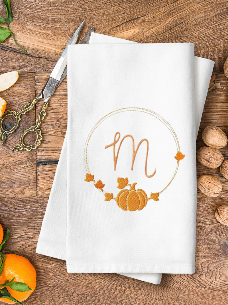 Personalized Housewarming gift of a tea towel with a monogrammed M in the middle of a pumpkin wreath.