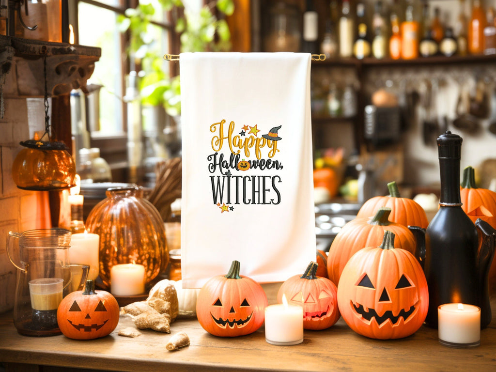 White tea towel on tea towel countertop holder amidst many pumpkins of different sizes as well as candles.