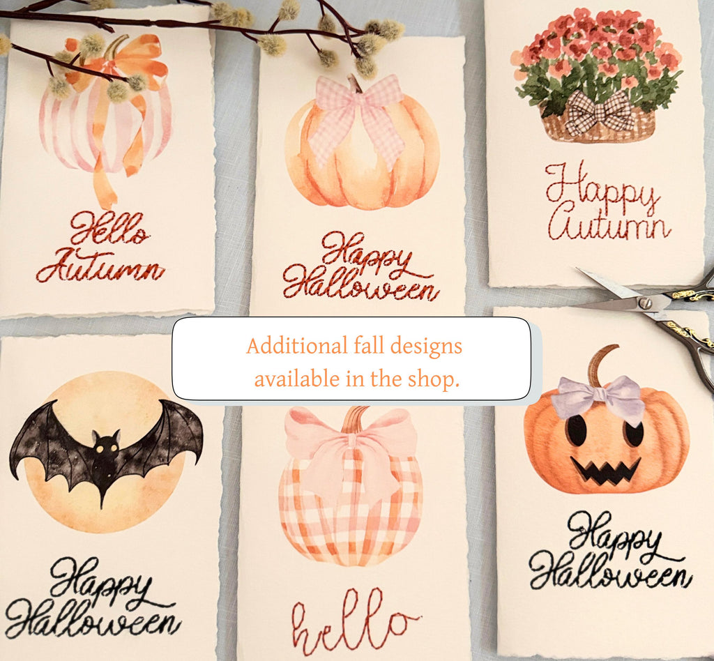 Additional cards that are available. Top left to bottom right: watercolor pumpkin orange bow with &quot;Hello Pumpkin&quot; embroidered in orange, watercolor pumpkin with pink bow &quot;Happy Halloween&quot; embroidered in pink, watercolor mums in basket with &quot;happy autumn&quot; embroidered in orange, a watercolor bat in front of the moon with &quot;Happy Halloween&quot; in black thread embroidered, a pink gingham pumpkin with pink bow with &quot;hello&quot; embroidered, jack o lantern wate